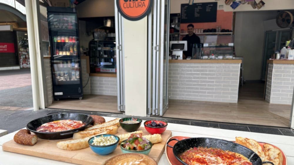 Various Cafe Cultura food offerings positioned on an outdoor table outside the cafe