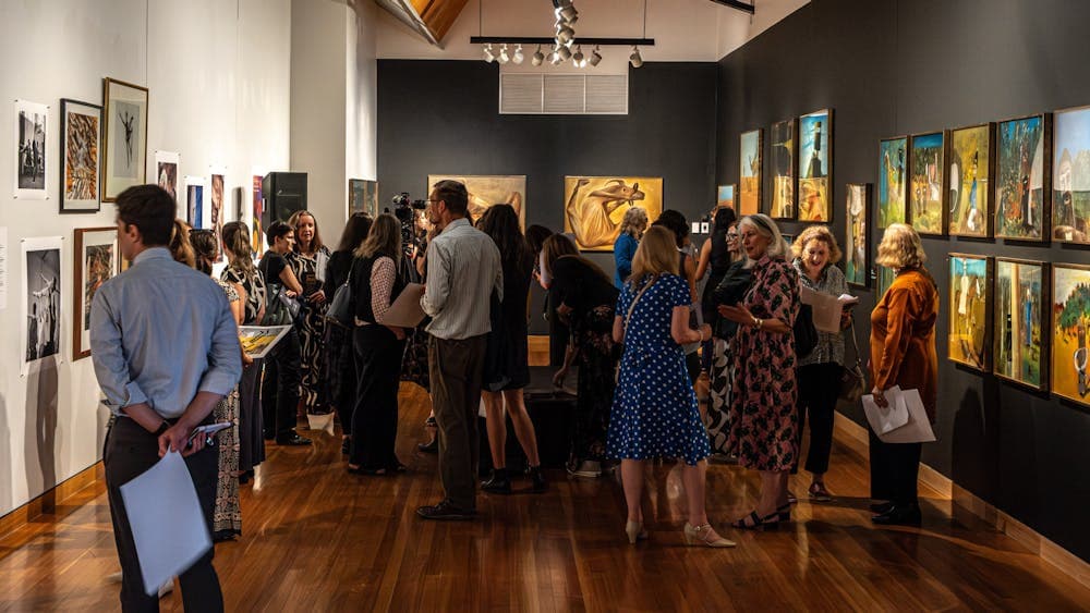 A group of people exploring the Nolan Collection at Canberra Museum + Gallery