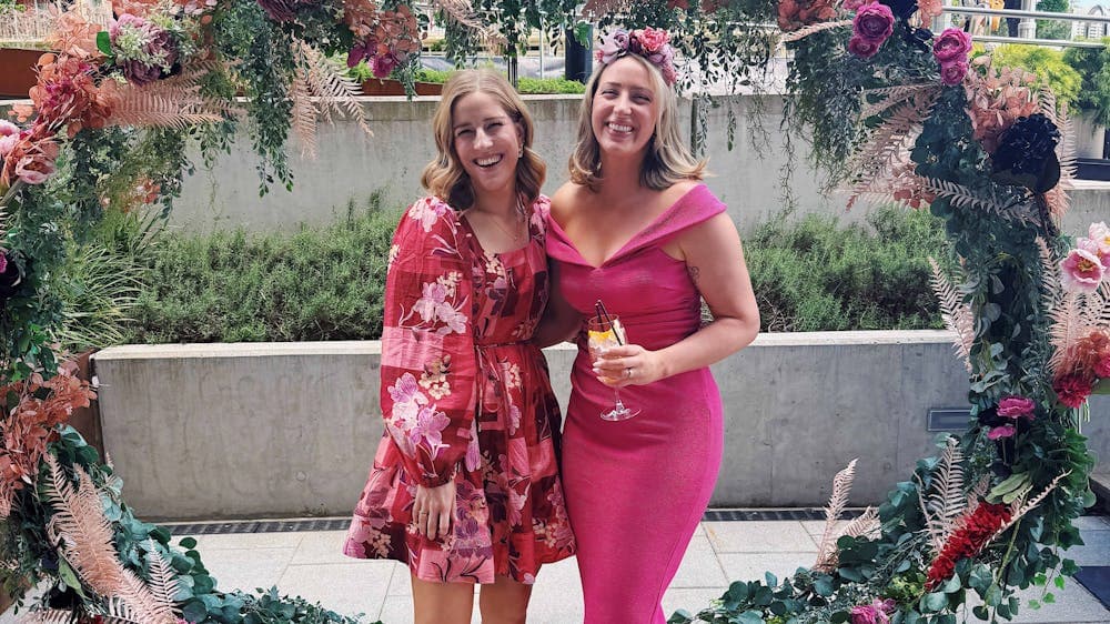 Two women dressed up for the races.