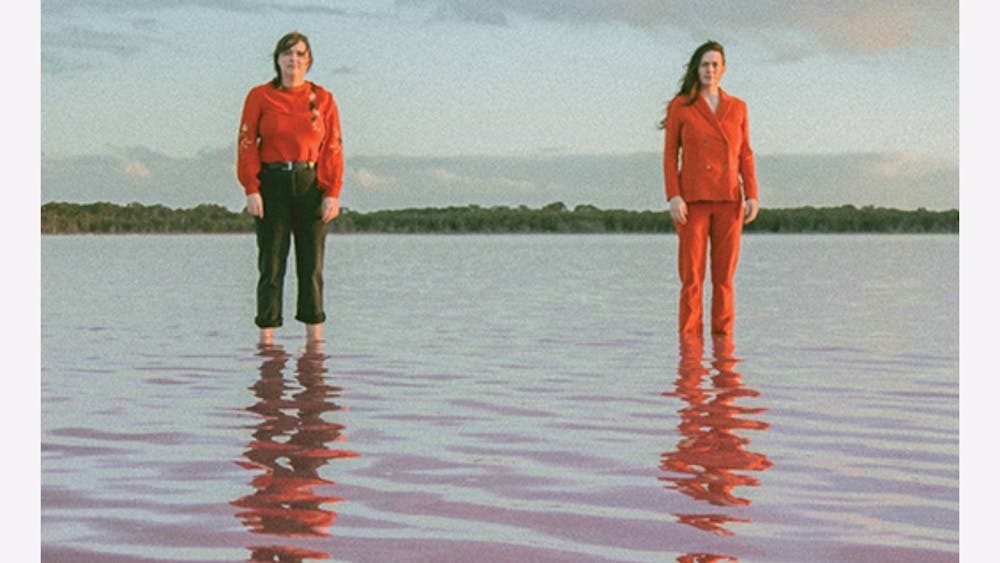 Photo of two women standing in shallow water
