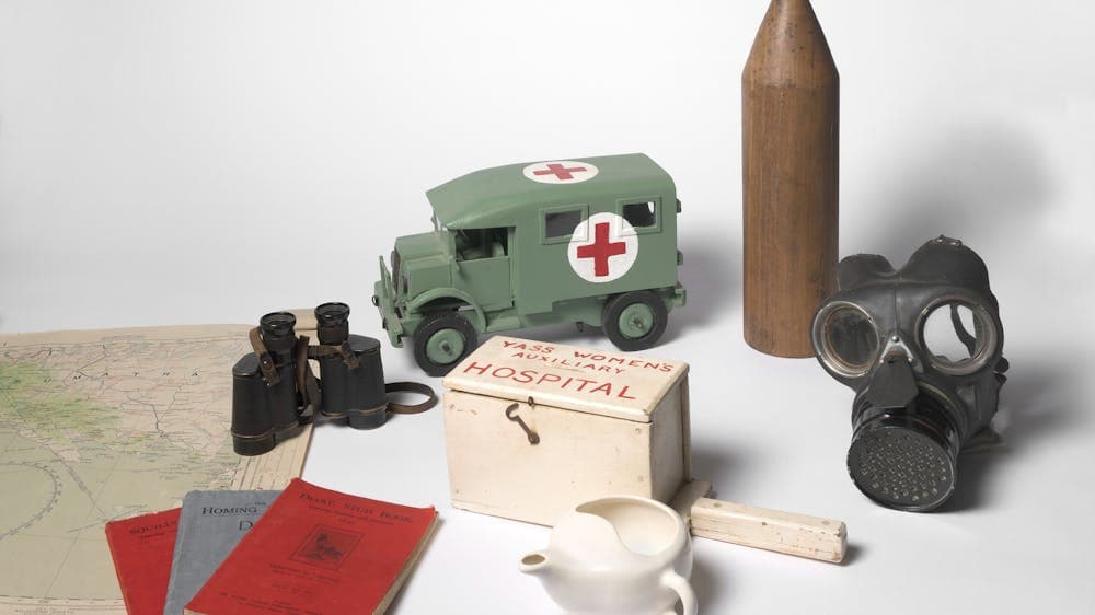 WWII Collectibles, medic truck, tea pot, miniature gurney, gas mask and documents