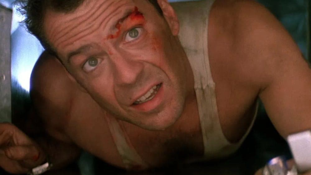 Man with blood on his face looking up squeezed in a tight space