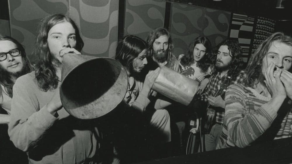Black and white group shot of men performing