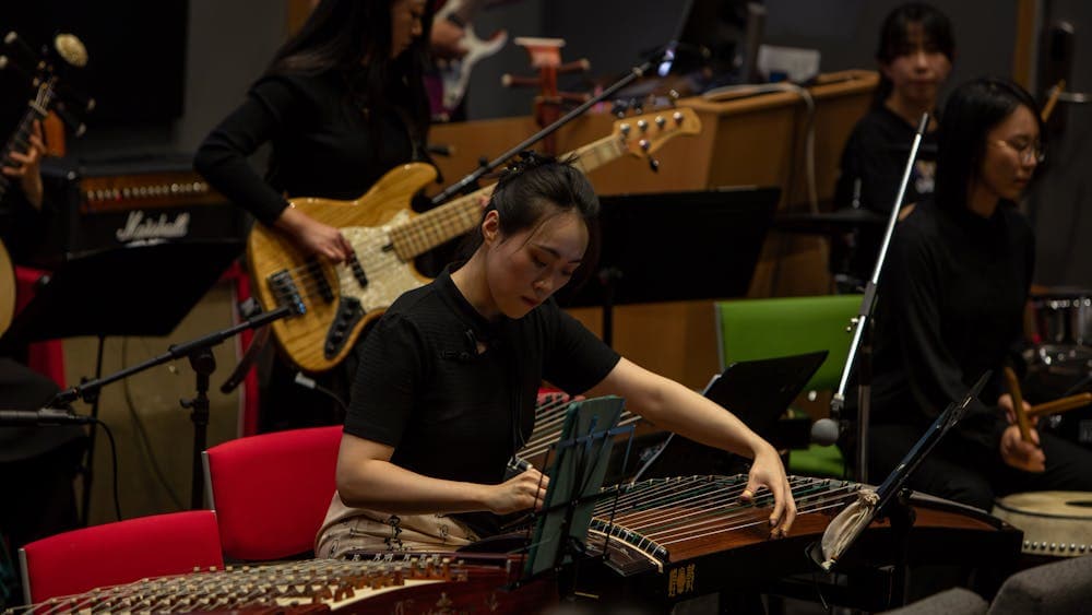 Member of ANU Chinese Classical Musical Ensemble performs on traditional Chinese instrument