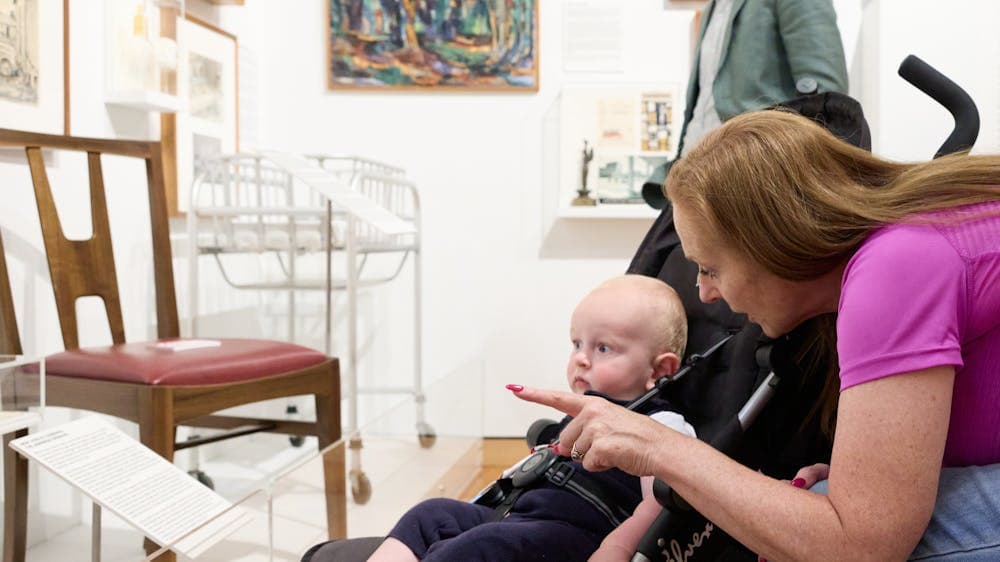 Mother showing child in pram art at Canberra Museum + Gallery