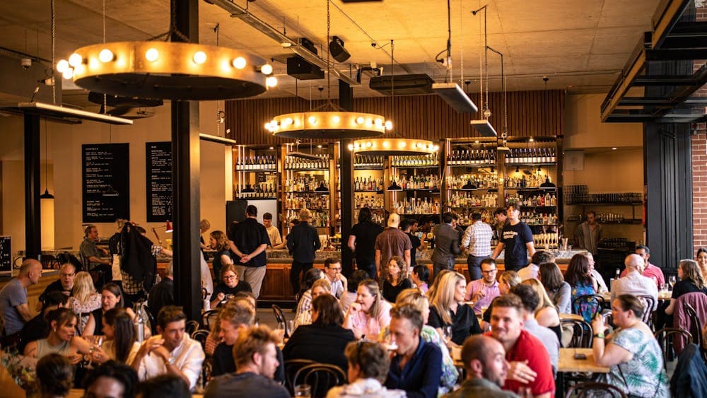 Food hall full of people and dim gold lighting