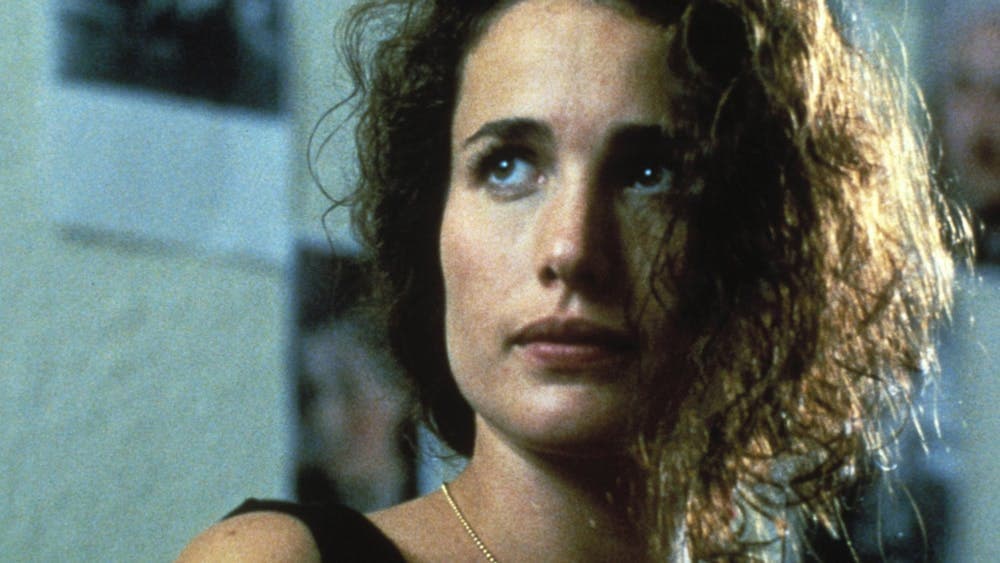 Woman with disheveled hair looking past the camera