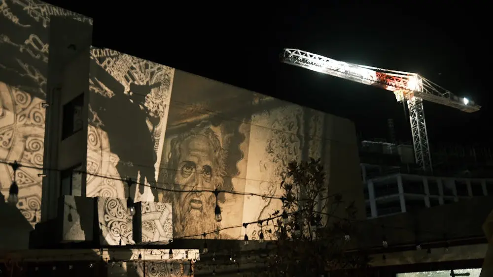 Image depicting an artwork being projected onto a large external building wall