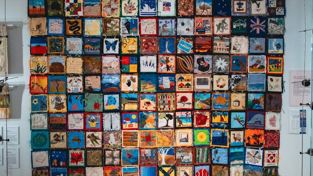 The Immigration Quilt with patches created by different makers to signify connection to country