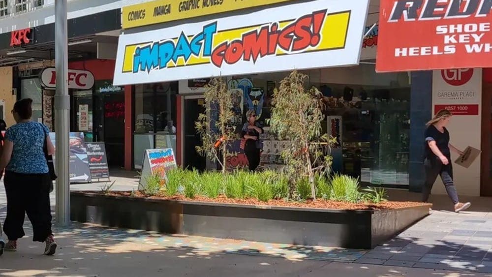 View of Impact Comics shopfront from Garema Place