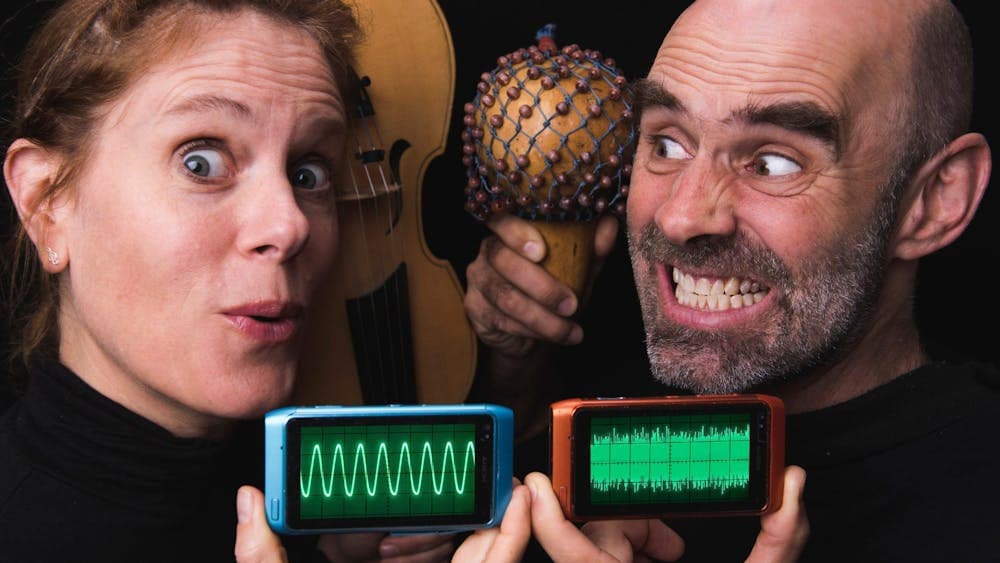 People holding percussion instruments and sound wave machines