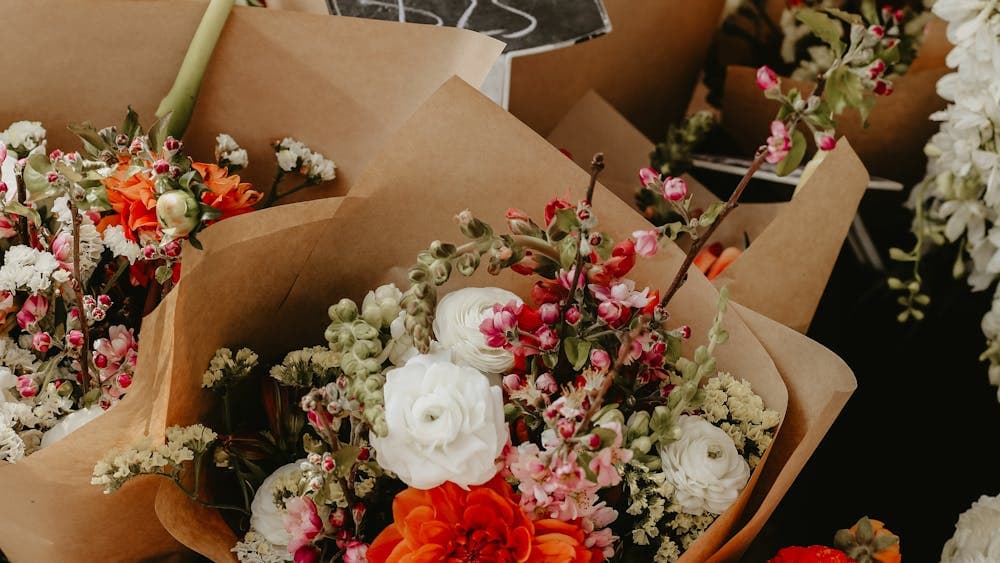 Mixed bunches of flowers wrapped up in brown paper