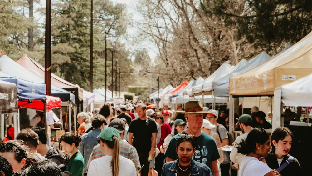 Image of people walking between the marquees at the Haig Park Village Markets