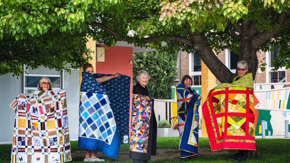 Canberra Quilters posing with quilts displayed at Civic Square