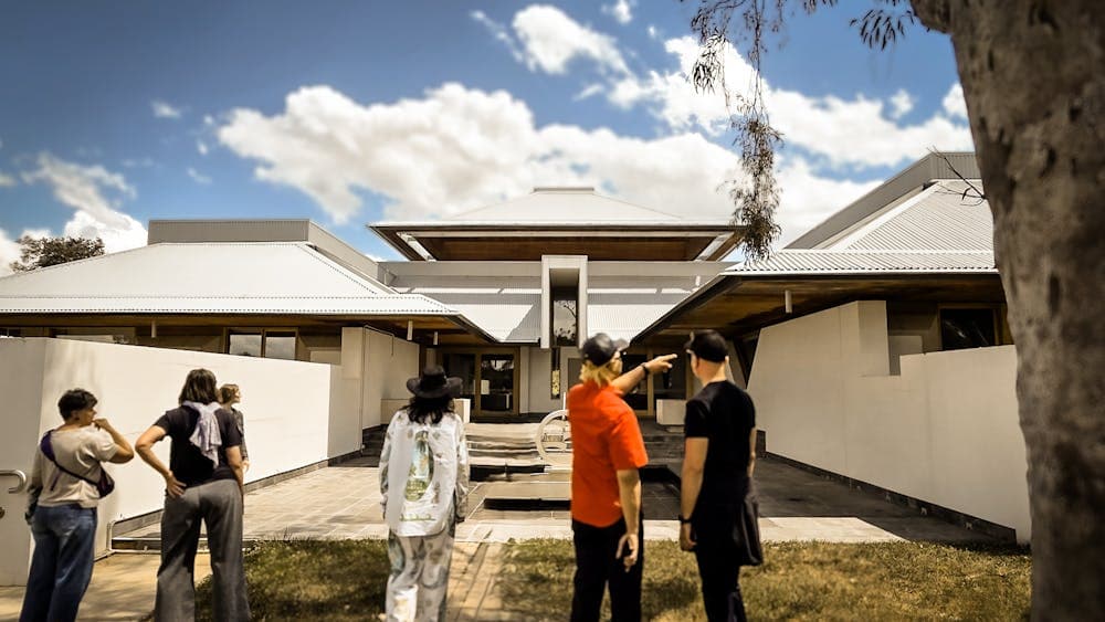 A group of participants observing an Enrico Taglietti designed building