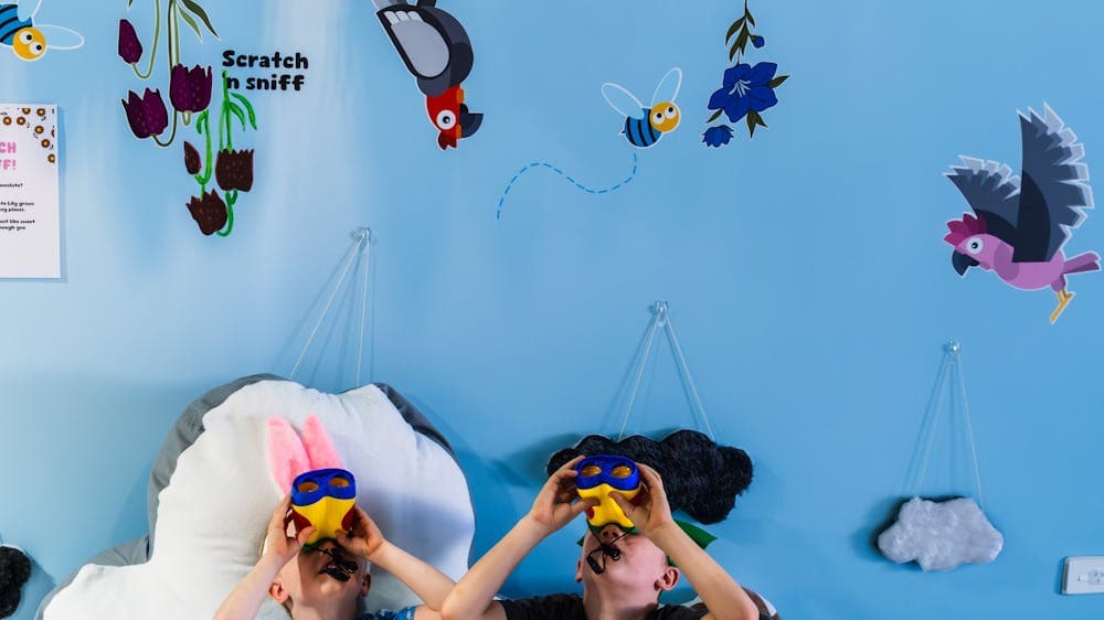 Two children participating in the scavenger hunt at Hop In