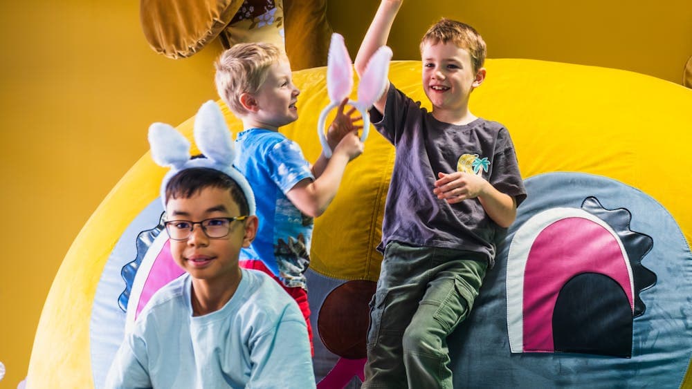 Three children interacting with bunny dearest