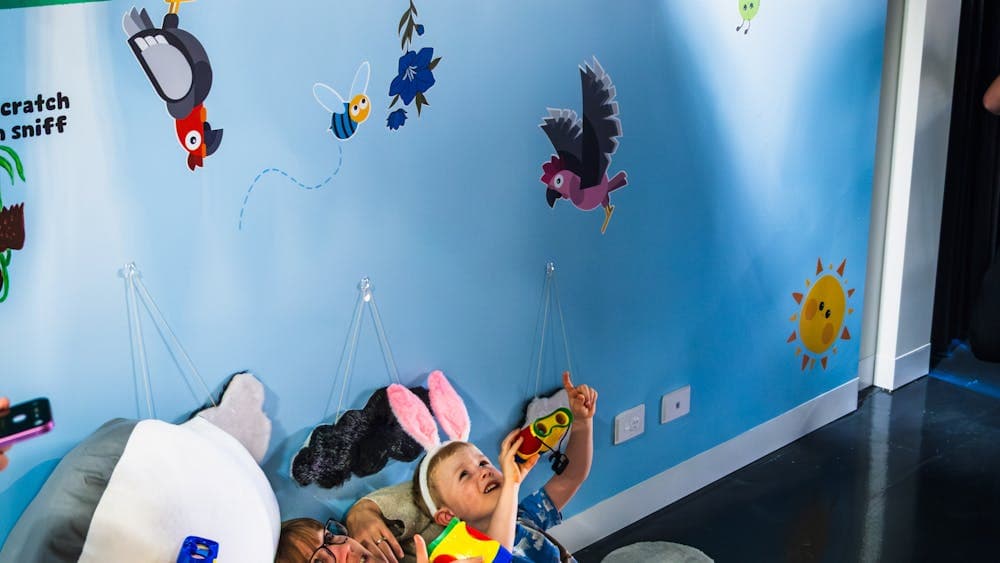 A mother and her two children partake in the scavenger hunt at Hop In