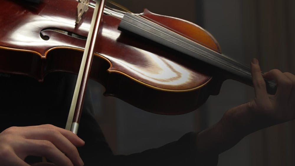 close up picture of a someone playing a viola