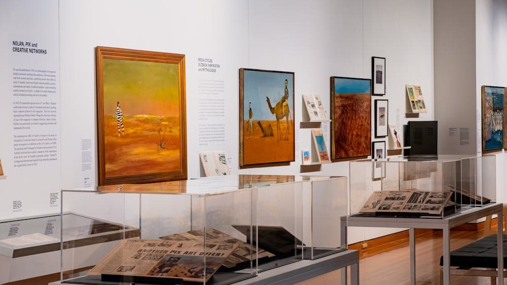 View of multiple Sidney Nolan paintings and vitrines with articles on Nolan