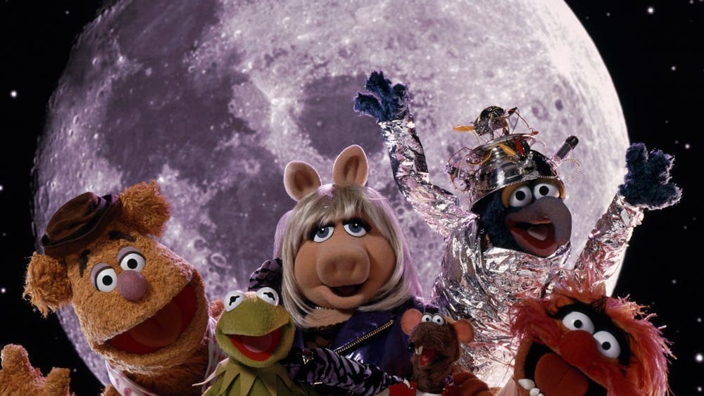 Six puppets looking excited at the camera with a planet in the background
