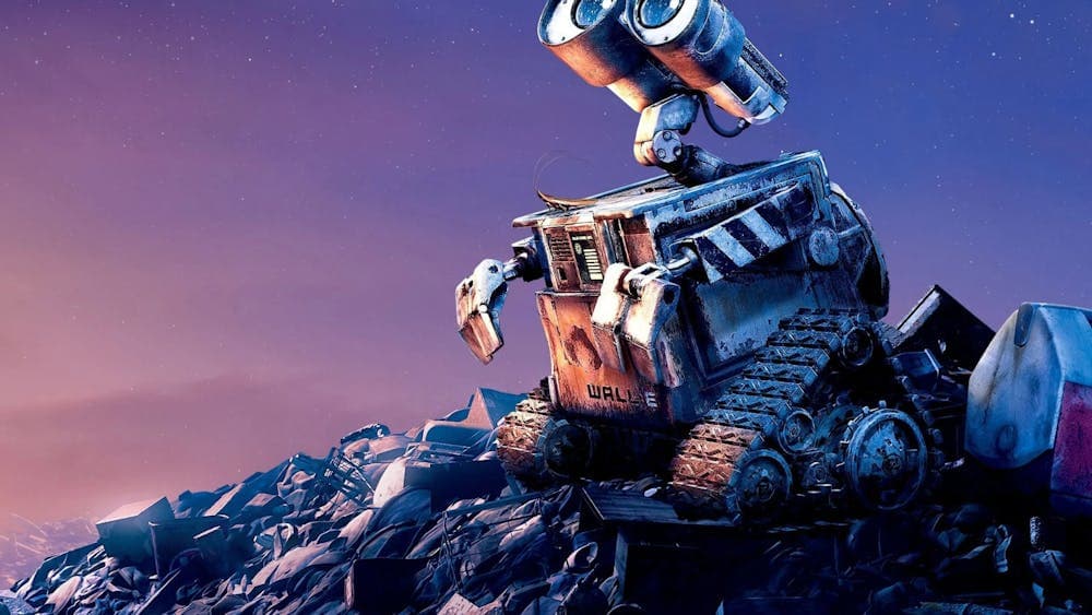 A small animated robot looks longingly up at the sky, sitting on a pile of rubbish