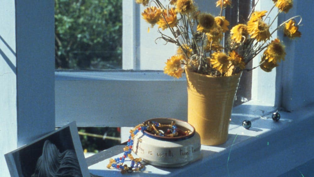 Photo of a windowsill with dry flowers and knick knacks