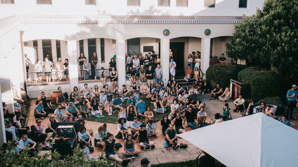 Image of people smiling and happy sitting in NFSA courtyard