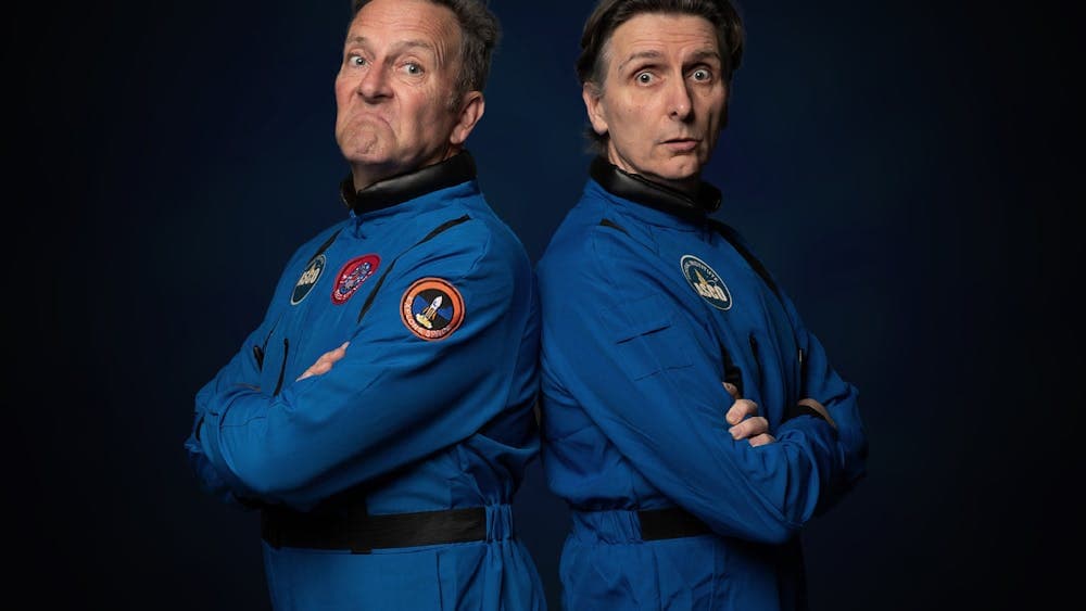 Comedians Colin Lane and Frank Woodley standing back to back dressed as astronauts