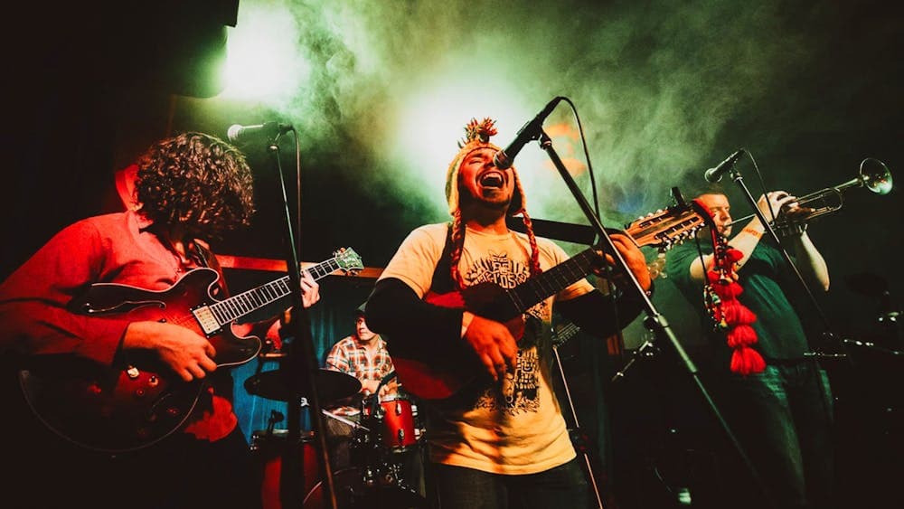 Still of a band performing with singer at front