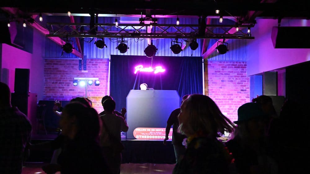 Louie Louie Stage with a DJ set up, Private Bin neon sign