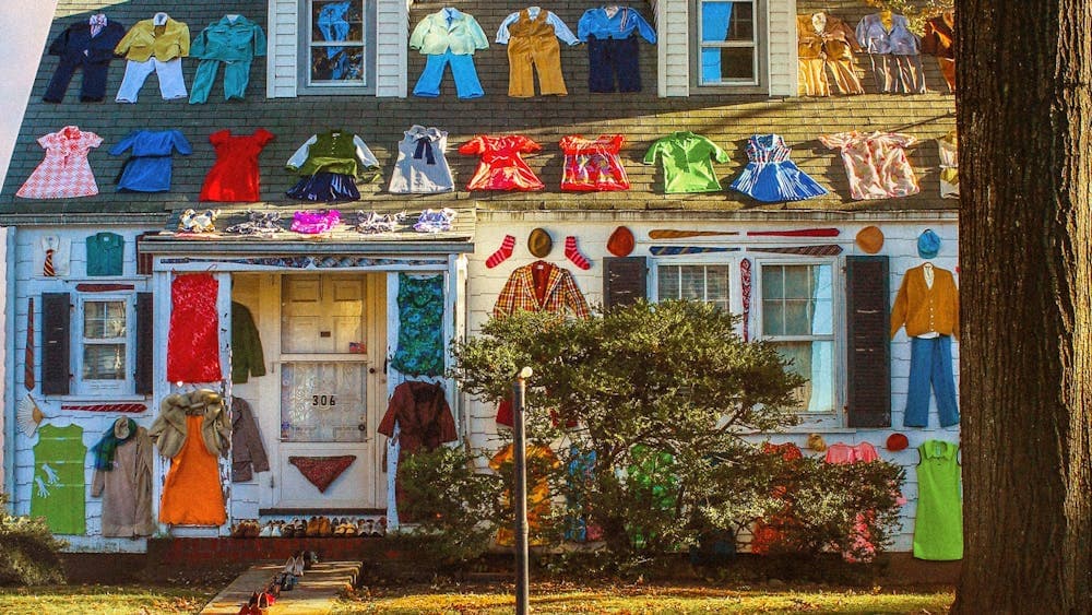 House and roof with various clothing laid out on the roof