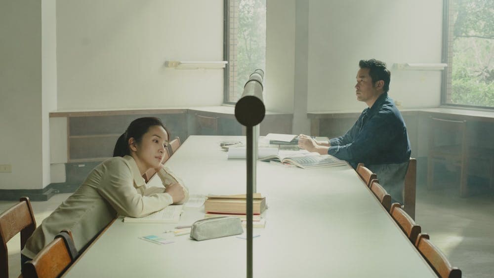 A women and a man sitting on opposite sides of the table