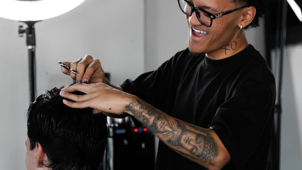 Our barber providing a precision haircut to a client at FANAEIANS Barber & Spa