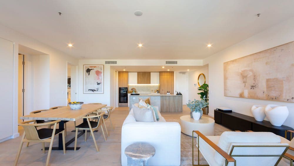 Open-plan apartment interior highlighting a spacious living room and adjacent kitchen area.