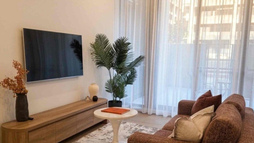 Cozy living space featuring ample natural light from windows and an entertainment center with a tele