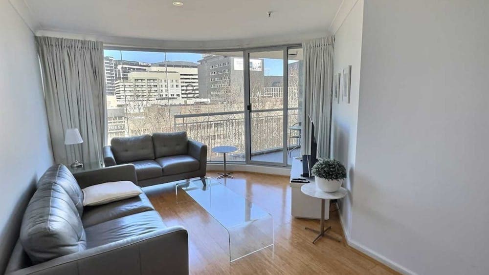 Bright open-plan apartment interior with large windows.