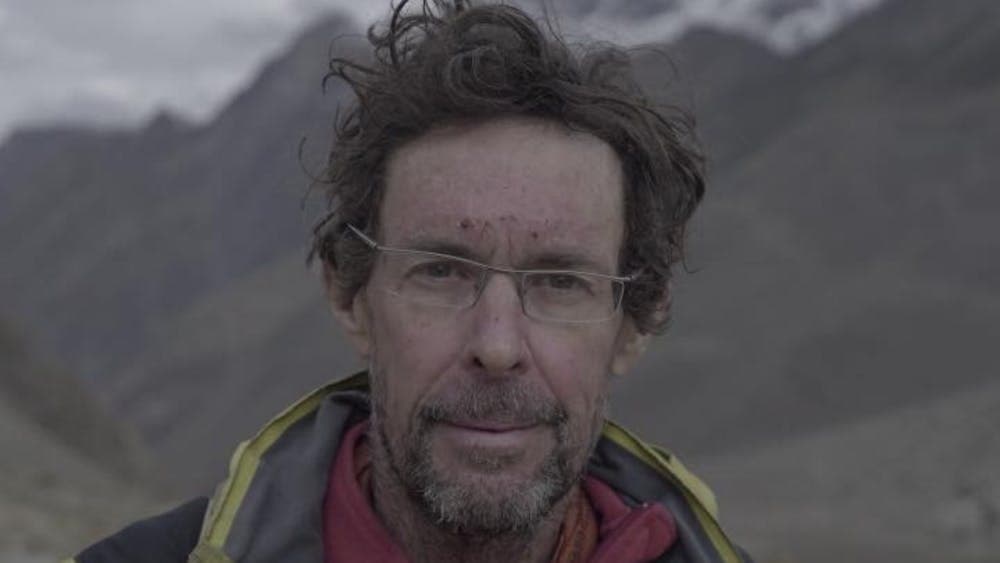 Man wearing glasses profile image with mountains in background