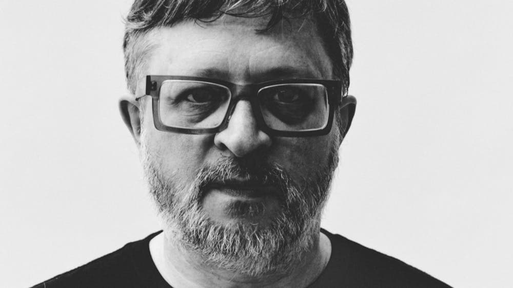 Black and white image of man wearing glasses looking at camera