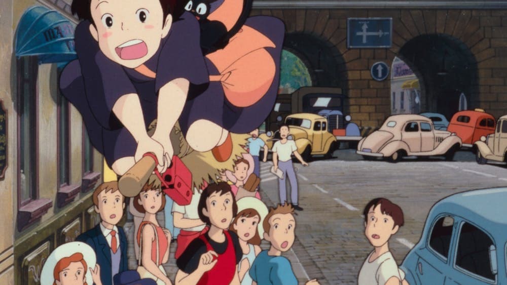 Animation of a young girl on a broomstick with cat flying over gasping crowds