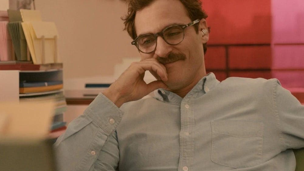 Man with moustache and glasses looking content smiling and looking down