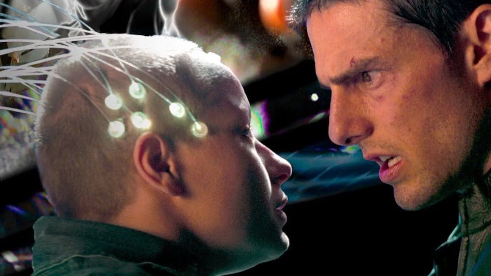 Man looks sternly at young child with nodes attached to the head