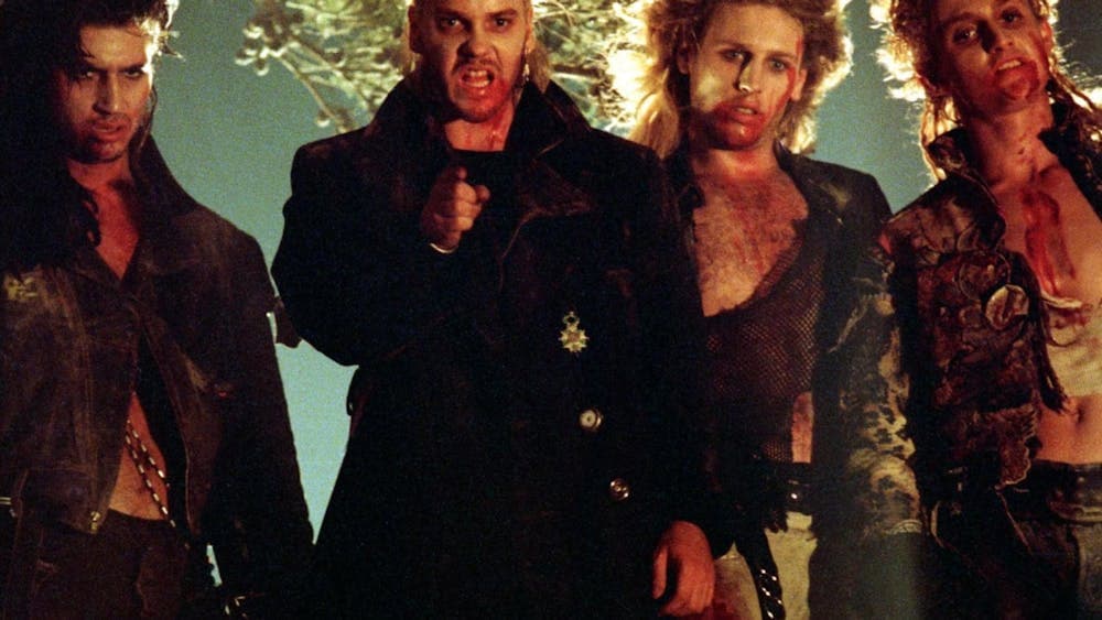 Four men standing covered in blood and gore