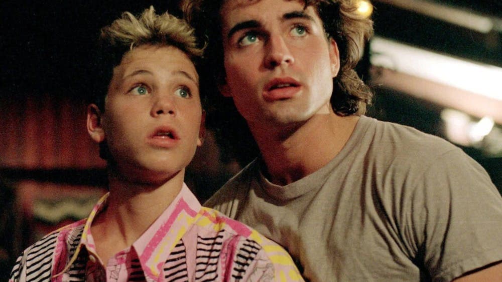 Two young boys looking up frightened