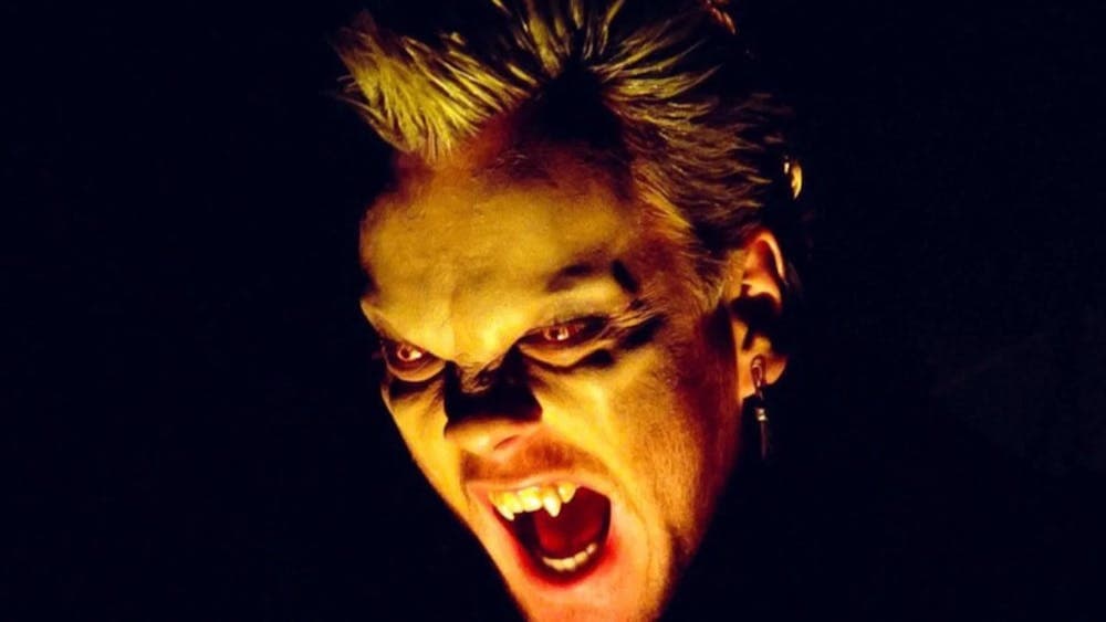 Close up of vampire baring teeth with glowing eyes