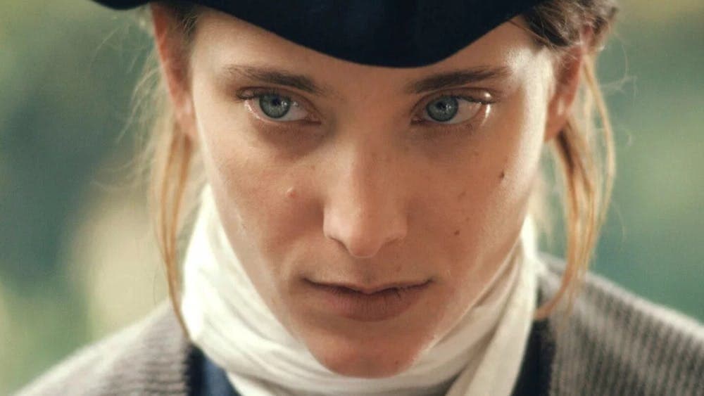Close up of person wearing hat, blue eyes and white cravat