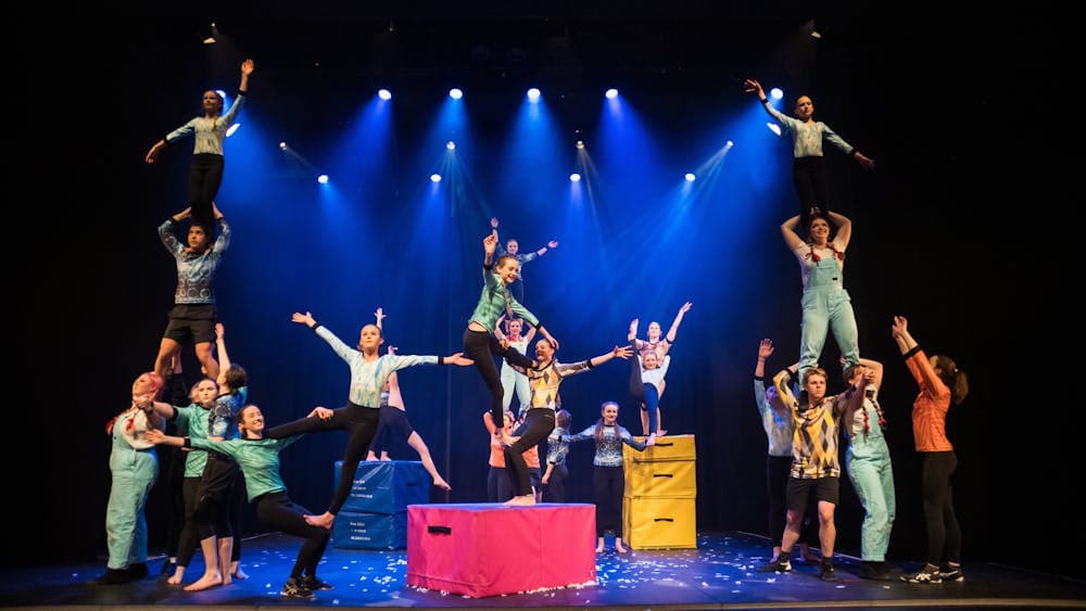 A group of young acrobats in a tableau of acrobatic forms