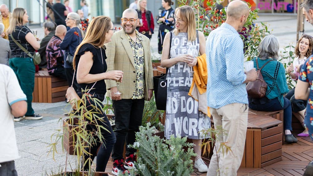 People talking in Civic Square at a launch event