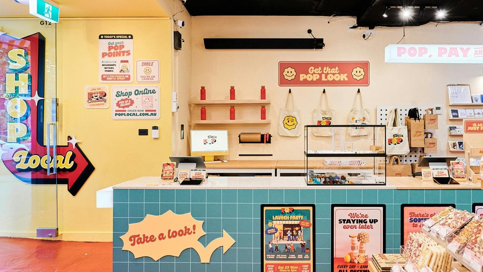 A bright and inviting interior of POP Canberra, featuring a checkout counter, merchandise,.