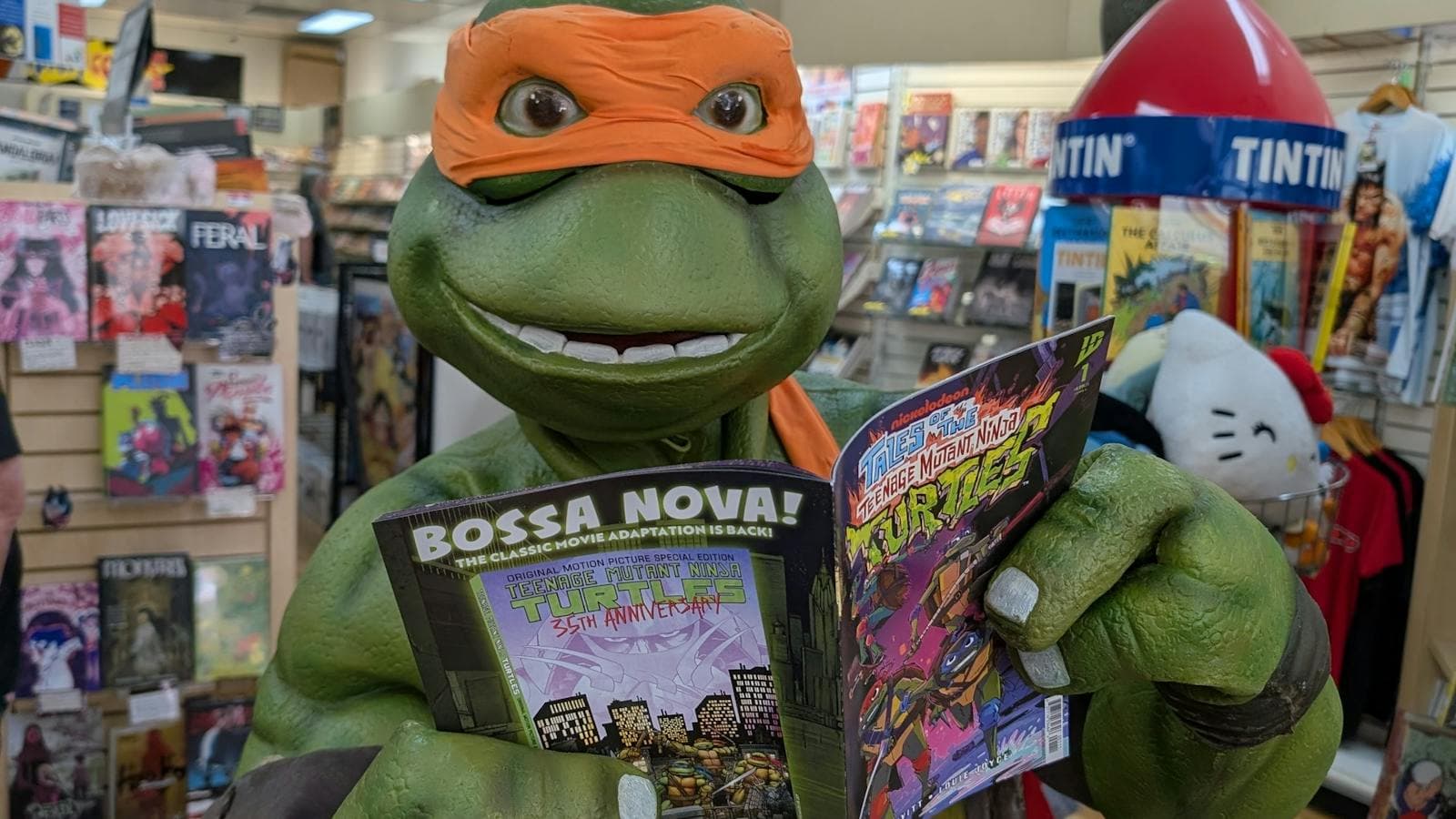 A Ninja Turtle reads a comic book in Impact Comics store